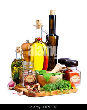 herbs, spices and bottles of olive oil isolated on a white background Stock Photo