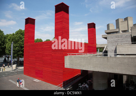 People walk past the National Theatre's temporary space The Shed Theatre on the Southbank. South Bank is a significant arts and entertainment district, it's riverside walkway busy with visitors and tourists. London, UK. Stock Photo