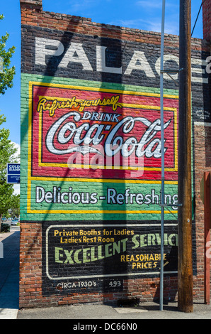 Advertising mural for Coca Cola on the wall of a store in historic downtown Ellensburg, Washington , USA Stock Photo