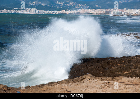 View with a big wave from Cala Estancia towards city of Palma de Mallorca and the cathedral in the background. Stock Photo