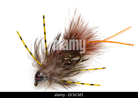 A closeup of a tied fluffy fishing fly lure isolated on a blue