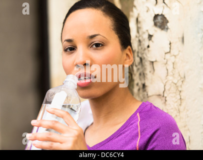 Portrait of female jogger with water bottle Stock Photo