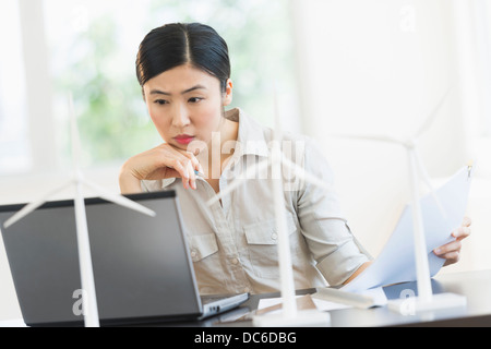 Female engineer working on laptop Stock Photo