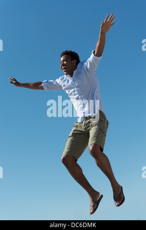 Happy man against clear sky Stock Photo