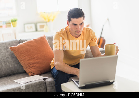 Man using laptop at home Stock Photo