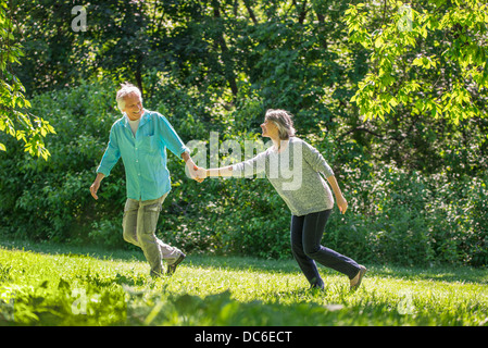 USA, New York, New York City, Central Park, Senior couple running in park Stock Photo