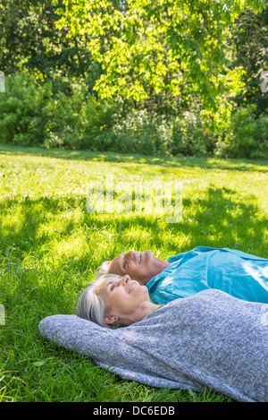 USA, New York, New York City, Central Park, Senior couple relaxing in park Stock Photo