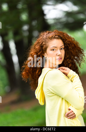 Portrait of young woman in park Stock Photo
