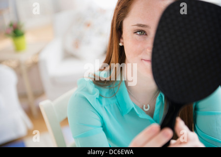 Teenage girl (14-15) with hand mirror Stock Photo