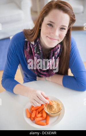 Portrait of teenage girl (14-15) with healthy snacks Stock Photo