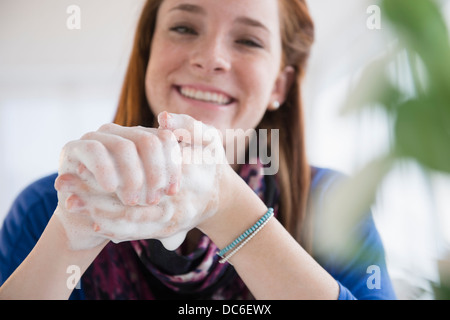 Teenage girl (14-15) washing hands Stock Photo