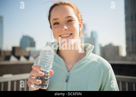 USA, New Jersey, Jersey City, Teenage girl (14-15) with bottle of water Stock Photo