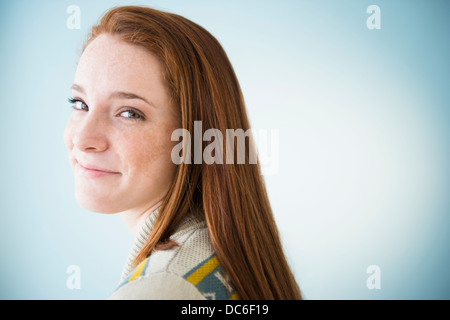 Portrait of smiling teenage girl (14-15), studio shot Stock Photo