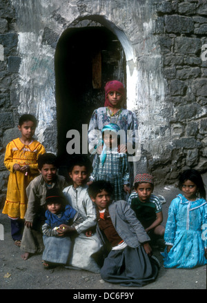 Young children standing in the doorway of a house in al-Hajjarah,  Yemen Stock Photo