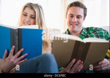 Couple on sofa reading Stock Photo