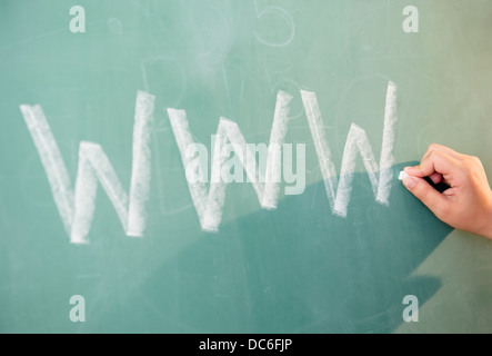 View of letters on blackboard and girl's hand Stock Photo