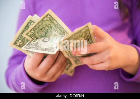 Girl (8-9) counting money Stock Photo