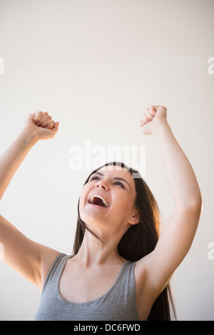 Young woman in victorious gesture Stock Photo