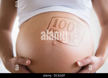Mid section of pregnant woman with label on belly Stock Photo