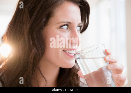 Portrait of young woman holding glass of water Stock Photo