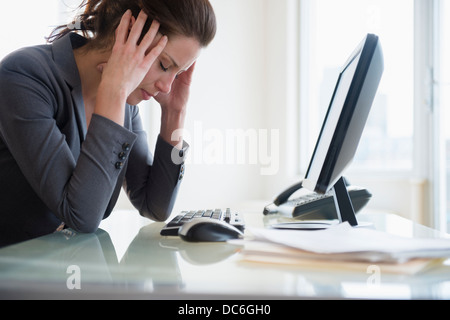 Portrait of overtired woman in office Stock Photo