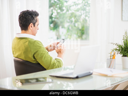 Side view of man using mobile phone Stock Photo