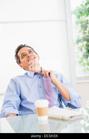 View of mature man relaxing in office Stock Photo