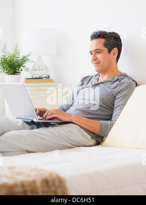 View of mature man using laptop at home Stock Photo