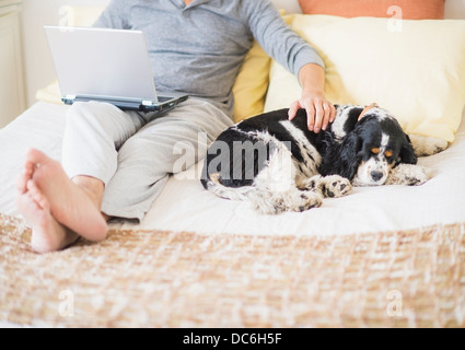 View of mature man using laptop at home Stock Photo