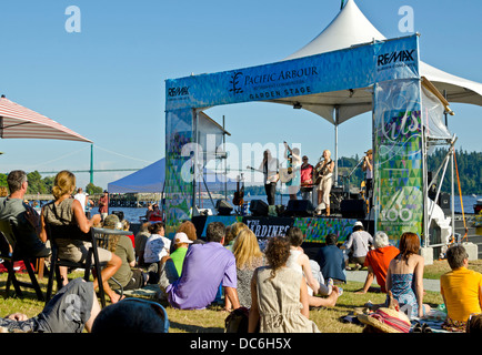 Outdoor summer music concert by the water in West Vancouver - The Jardines perform in front of a crowd at Ambleside Park. Stock Photo