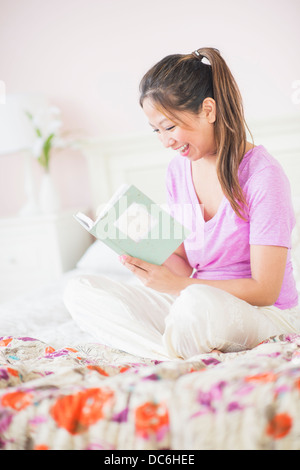 Young woman reading book Stock Photo