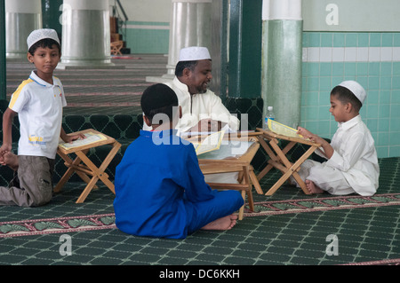 Koran lessons at the Jamae Mosque in Singapore's Chinatown district Stock Photo