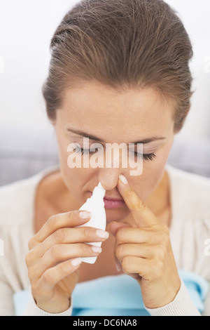 Woman using nasal drops Stock Photo