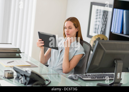 Business woman using tablet pc in office Stock Photo