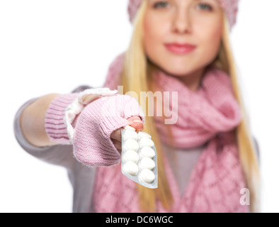 Closeup on pills pack in hand of teenager girl in winter hat and scarf Stock Photo