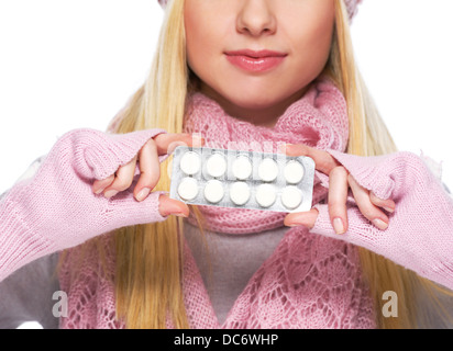 Closeup on pills pack in hand of teenager girl in winter gloves and scarf Stock Photo