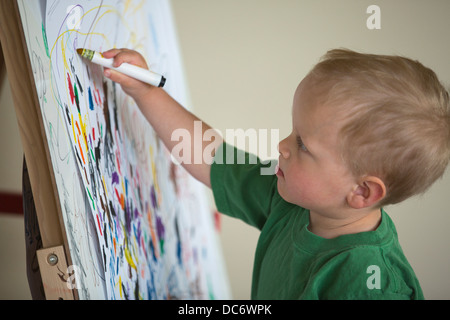 Toddler drawing on wall Stock Photo