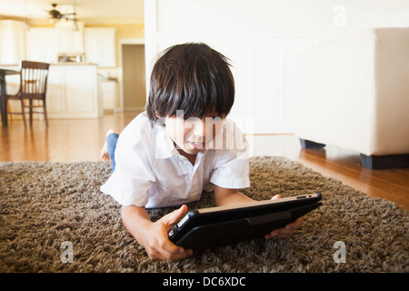 Boy (8-9) using digital tablet Stock Photo