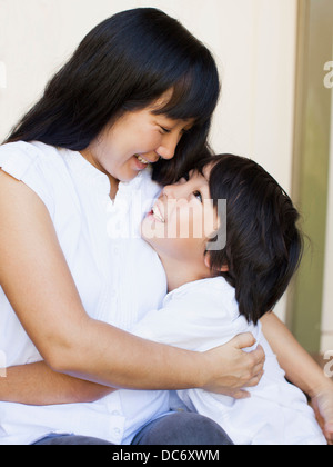 Boy (8-9) embracing mother Stock Photo