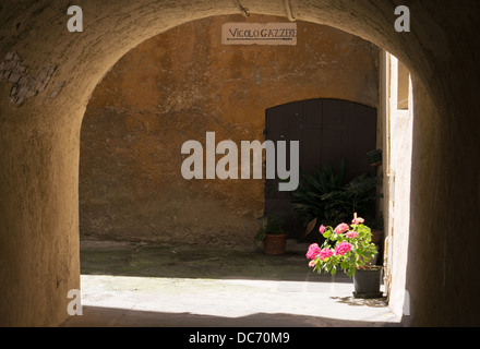 Light and shade under an arch and through an alley in Salo, Italy, Europe Stock Photo