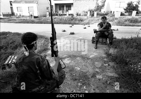 Croatian Militia checkpoint on the streets of Sarvas on the frontline between Croat and Serb forces in August 1991. Anti tank mines litter the road. Stock Photo