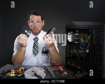 Man with computer and various hardware components Stock Photo