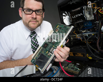 Man with computer and various hardware components Stock Photo