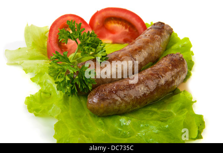 Grilled sausage and vegetables over white Stock Photo