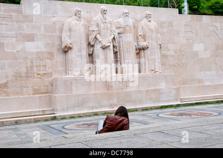 Tourist woman siting  in front of the International Monument to the Reformation ,Geneva, Switzerland, Europe Stock Photo