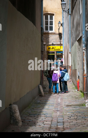 Students discuss something after school in old city, Lyon, France, Europe. Stock Photo