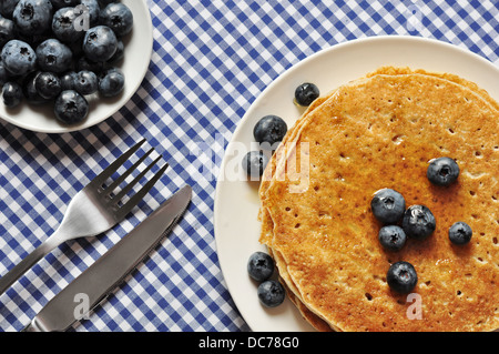 Delicious pancakes with fresh blueberries and maple syrup