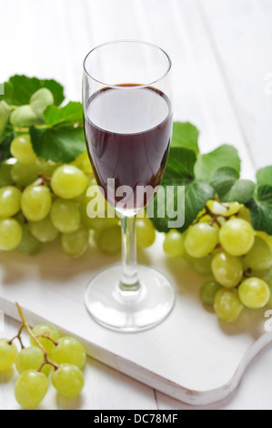 Red wine and grapes on wooden background Stock Photo
