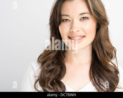 Beautiful Asian American girl with white t-shirt and orthodontic braces Stock Photo