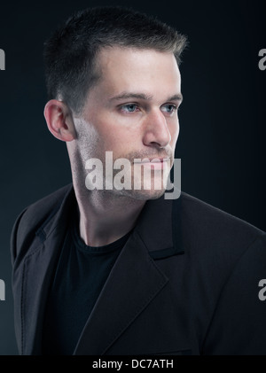 Handsome Caucasian man in his twenties wearing black t-shirt and jacket Stock Photo